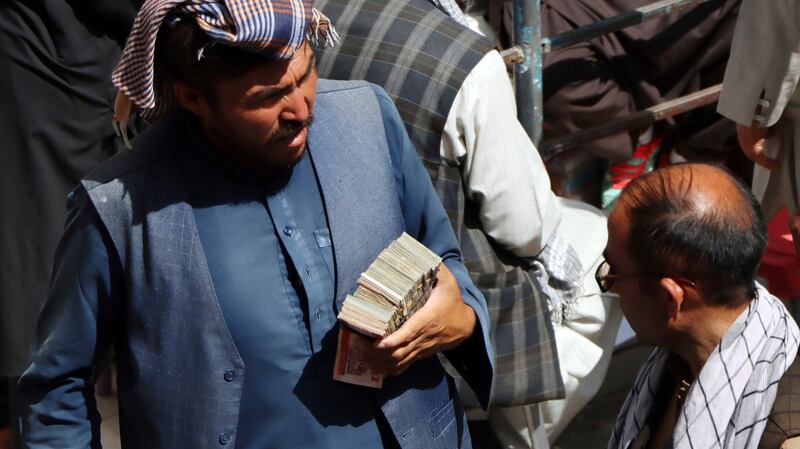 Afghan black market money changers wait for customers in Sarai Shahzada market in Kabul. Photograph: Wali Sabawoon/AP