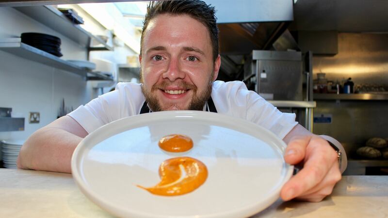 Daniel Hannigan, sous chef at Richmond restaurant in Dublin, with the logo he created for Food for Thought