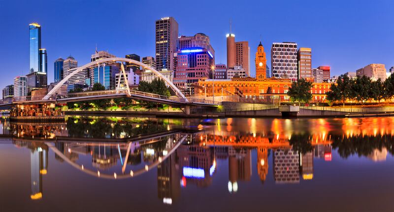 Melbourne CBD cityline at sunrise reflecting in the Yarra river waters. Photograph: Taras Vysnya/Getty/iStock