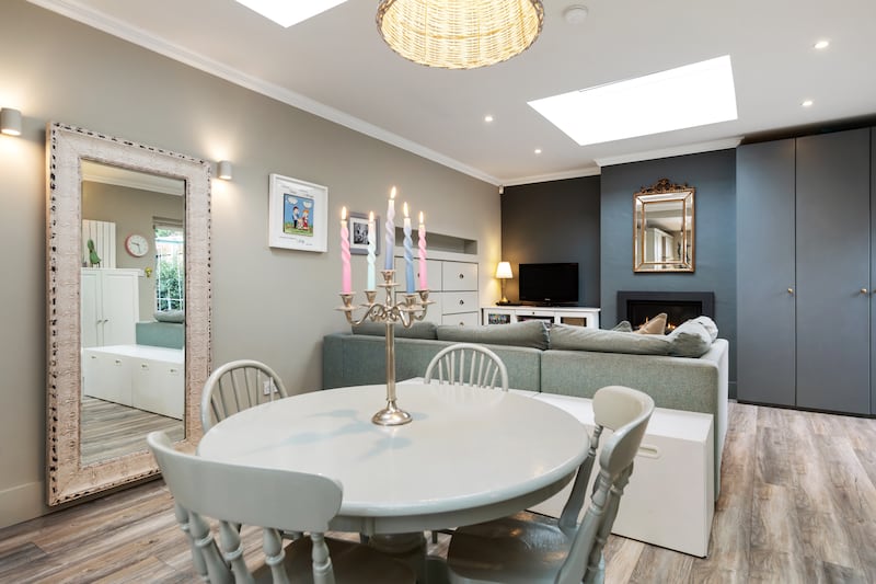 A dining space divides kitchen and living areas