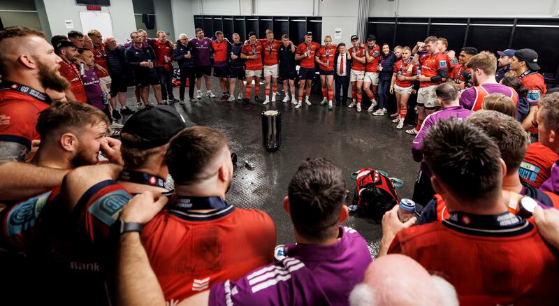 Munster players and staff gather together to listen to Peter O'Mahony's speech after the final whistle. Photograph: James Crombie/Inpho