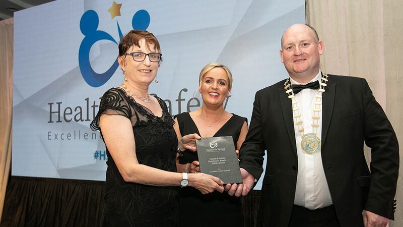 Patricia Ennis Gillen, awards judge, presents the Health & Safety Excellence Award - Public Sector to Theresa McCabe and Turlough McGovern, Longford County Council