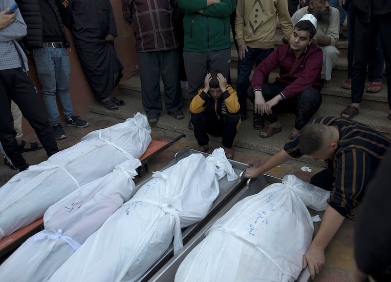 Relatives of the Sharab family, who died during Israeli air strikes in the southern Gaza Strip, mourn next to their wrapped bodies outside Nasser Hospital in Khan Younis on December 4th. Photograph: Haitham Imad/EPA