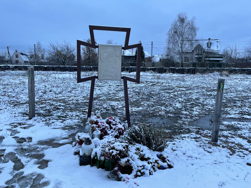 A memorial cross behind the Church of Andrew the Apostle in Bucha, where more than 100 bodies were exhumed from a mass grave after Russia's occupation of the town early this year. Photograph: Daniel McLaughlin