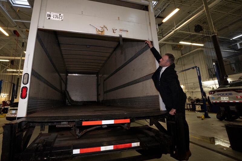 Police officers open the back of a truck recovered during the investigation. Photograph: Arlyn McAdorey/The Canadian Press via AP