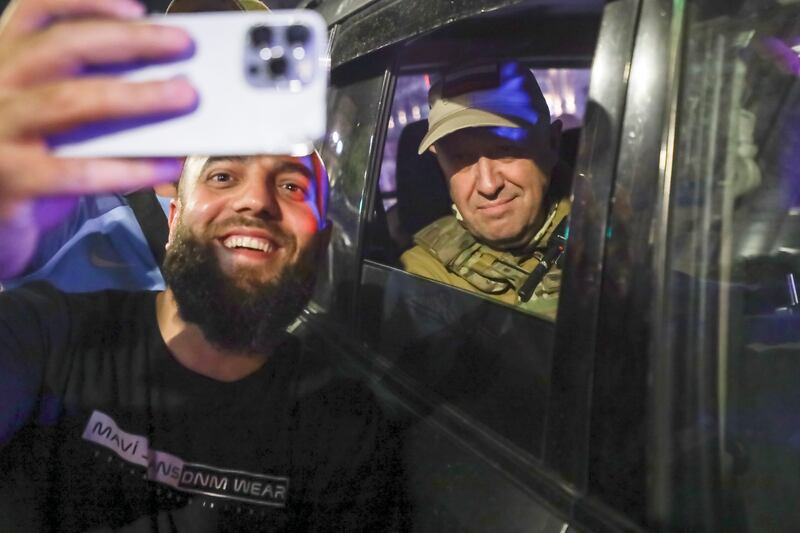 Yevgeny Prigozhin poses for a photograph with a local civilian as he leaves Rostov-on-Don on Saturday. Photograph: AP