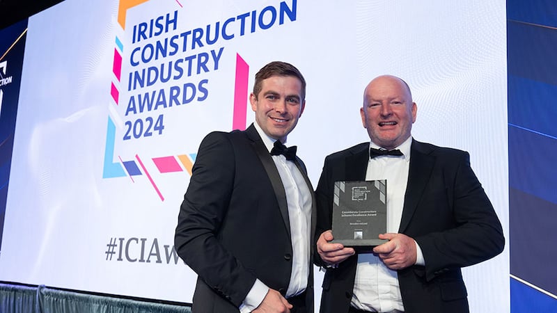 Kevin Hutchinson, head of social impact at Considerate Constructors Scheme, presents the considerate constructors scheme excellence award to Russell Drew, Breedon Ireland