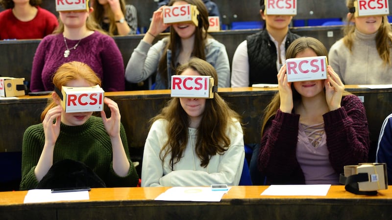 Students watch a real-life 3D operation using virtual reality at the Royal College of Surgeons in Ireland open day for some hands-on experience. Photograph: Dara Mac Dónaill