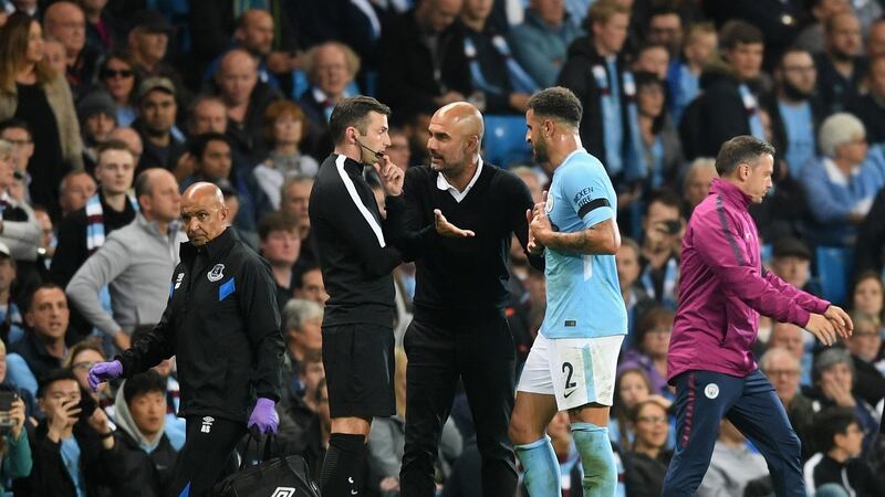 Pep Guardiola and Kyle Walker remonstrate with fourth official Michael Oliver after the fullback’s sending off. Photograph: Michael Regan/Getty