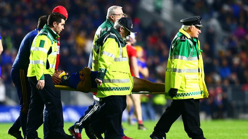 Tipperary’s John O’Dwyer is taken from the pitch by medical staff.  Photograph: Ken Sutton