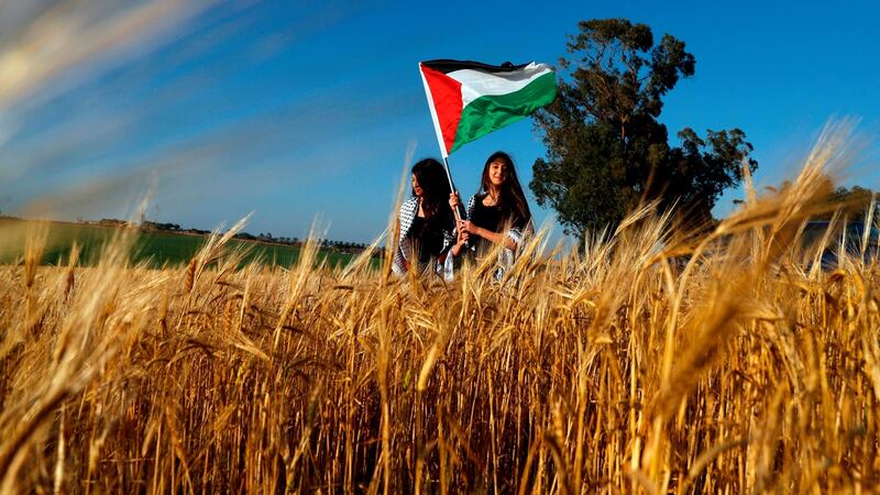 Palestinian activists wave the national flag during a demonstration on Saturday along Israel’s border with Gaza. Photograph: Getty