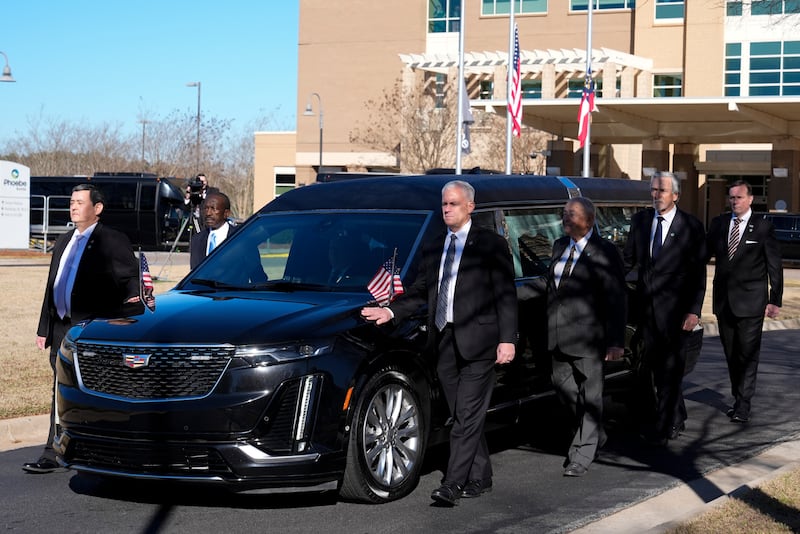 Former and current US Secret Service agents walk with the hearse of president Jimmy Carter. Photograph: Alex Brandon/AP