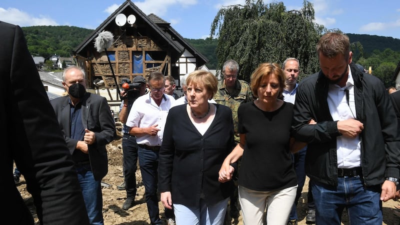 German chancellor Angela Merkel and Rhineland-Palatinate state premier Malu Dreyer walk through the flood-ravaged village of Schuld. Photograph: Christof Stache/Pool/AFP via Getty