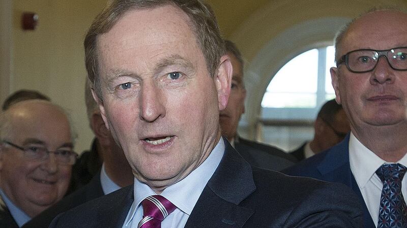 Taoiseach Enda Kenny arriving to launch the latest edition of Nealon’s Guide, edited by Tim Ryan (right). Photograph: Dave Meehan