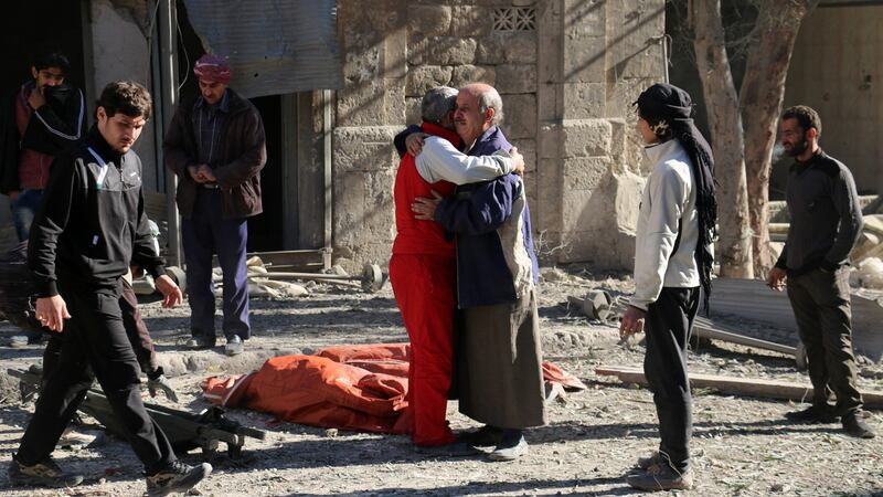 Syrians comfort each other on Saturday following a reported air strike on Aleppo’s rebel-held neighbourhood of Bab al-Nayrab. Photograph: Ameer al-Halbi/AFP/Getty Images