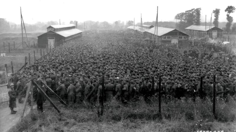 German prisoners of war captured after the D-Day landings in Normandy are guarded by US troops at a camp in Nonant-le-Pin, France, August 21st, 1944. Photograph: US National Archives handout via Reuters.