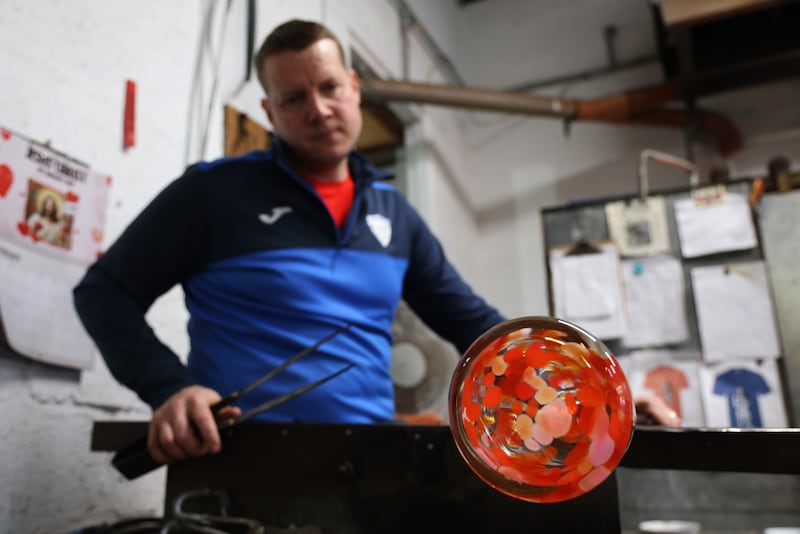 Rory Leadbetter handling and shaping hot glass.