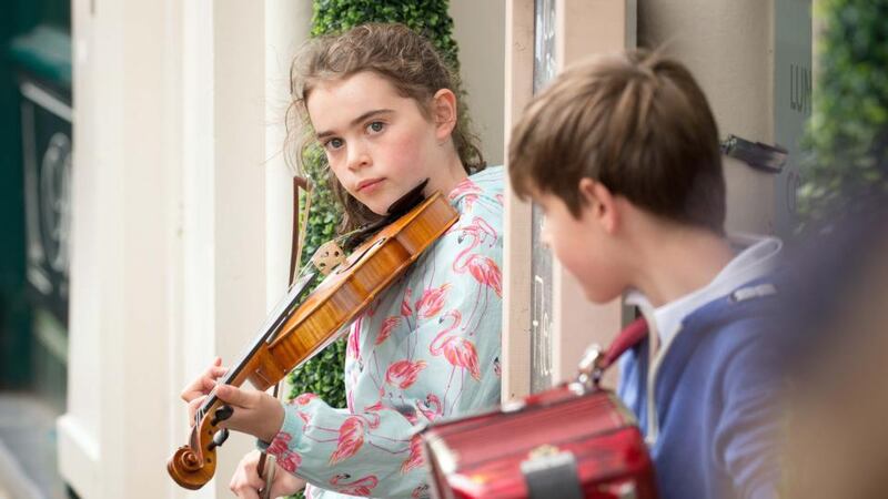 Aoibheann Donohoe busks on O’Connell St at the Fleadh. Photo: James Connolly