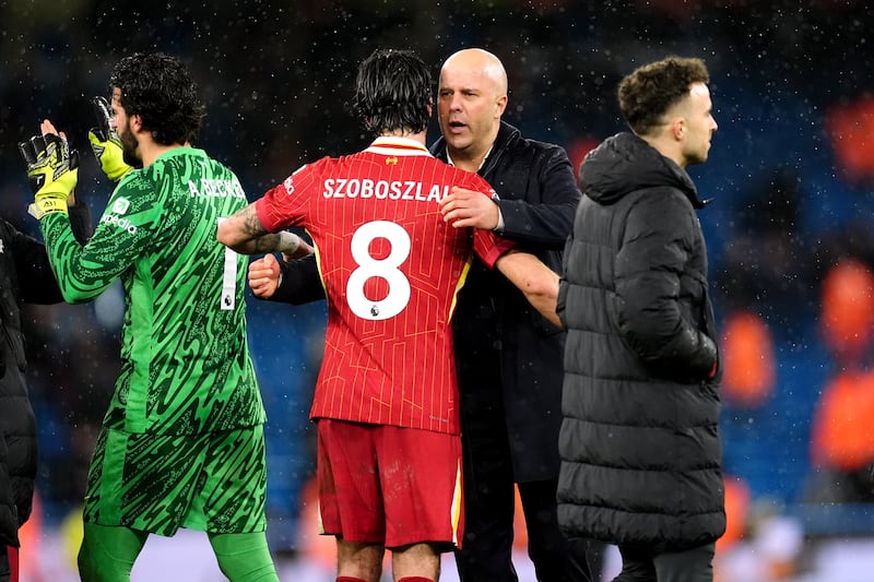 Liverpool manager Arne Slot congratulates Dominik Szoboszlai after the win over Manchester City at the Etihad Stadium. Photograph: Martin Rickett/PA