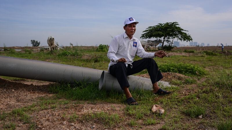 An opposition Cambodia National Rescue Party supporter takes a cigarette break during the campaign rally ahead of the commune elections in Phnom Penh in May 2017. Photograph: Lauren Crothers