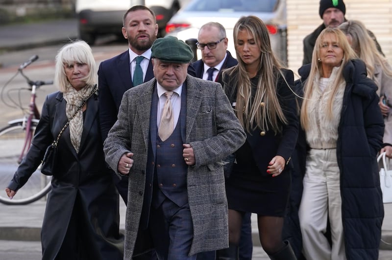 Mixed martial arts fighter Conor McGregor (second left), with friends and family, including Cllr Philip Sutcliffe, Independent Ireland general election candidate for Dublin South -Central and McGregor's boxing coach (front), arriving at the High Court in Dublin on Friday. Photograph: Brian Lawless/PA Wire 