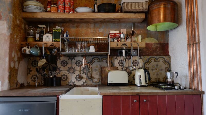 Jim Cogan repurposed the house’s old hot water tank for a new cooker hoodabove the family’s two-ring hob. Photograph: Alan Betson/The Irish Times