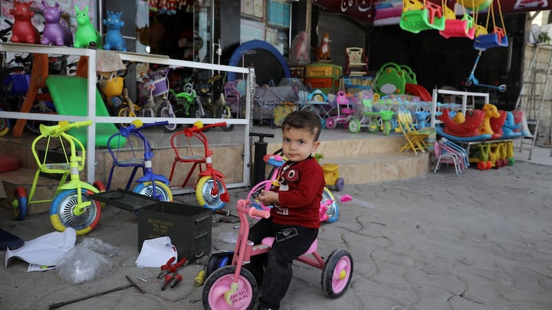 A boy on his bicycle in front of a toy store, in eastern Mosul, Iraq. Photograph: Marko Djurica/Reuters