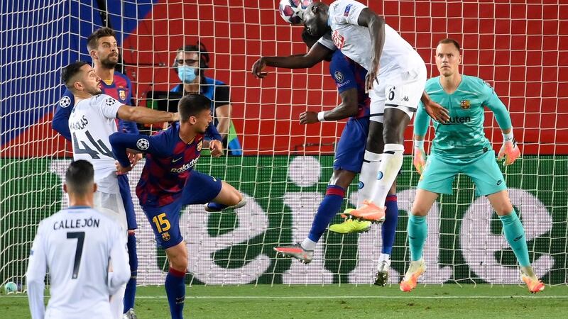 Napoli’s  Kalidou Koulibaly leaps to head the ball during his side’s defeat to Barcelona. Photograph: Lluis Gene/Getty/AFP