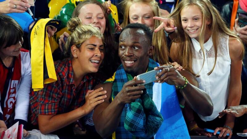 Jamaica’s Usain Bolt poses for photographs with fans after Jamaica won the relay final at the 2014 Commonwealth Games in Glasgow. Photograph: Reuters