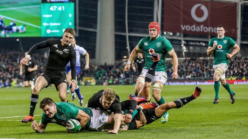 Jacob Stockdale breaks through the tackles of Damian McKenzie and Aaron Smith to score Ireland’s try against New Zealand. Photograph: Gary Carr/Inpho