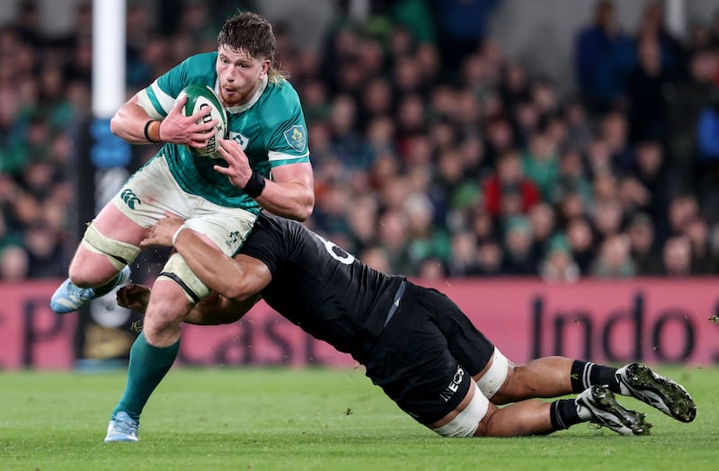 Ireland’s Joe McCarthy is tackled by New Zealand's Wallace Sititi. Photograph: Dan Sheridan/Inpho