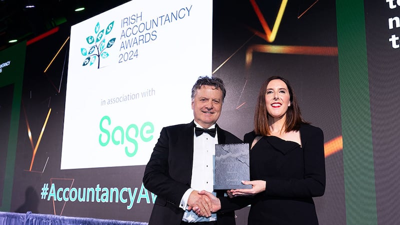 Peter Brady, co-founder and chief revenue officer, Financefair, presents the finance team of the year - sme award to Caroline Sherry, Hostelworld.