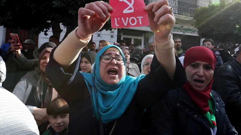 An Algerian woman holds a placard reading in Arabic “No” as protesters marched on Wednesday ahead of Thursday’s election. Photograph: Mohamed Messara/EPA