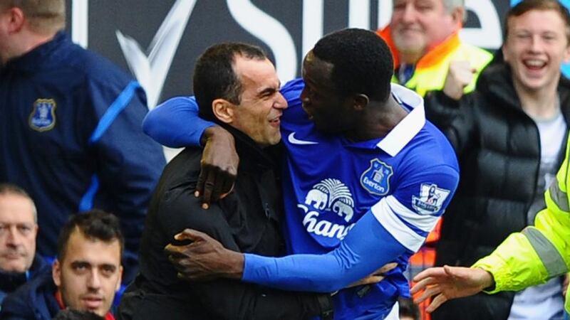 Romelu Lukaku of Everton celebrates scoring against Arsenal with manager Roberto Martinez  at Goodison Park. Photograph:  Laurence Griffiths/Getty Images