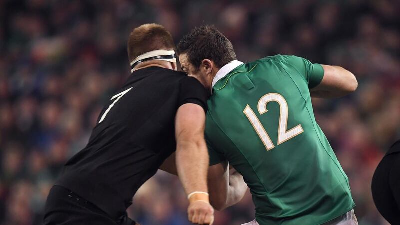 Robbie Henshaw of Ireland is tackled by Sam Cane in the return match in Dublin.