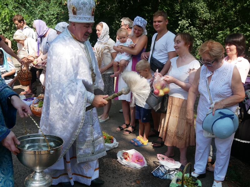 Fr Vasily Vyrozub performs a symbolic blessing of fruit. Photograph: Ed Vulliamy