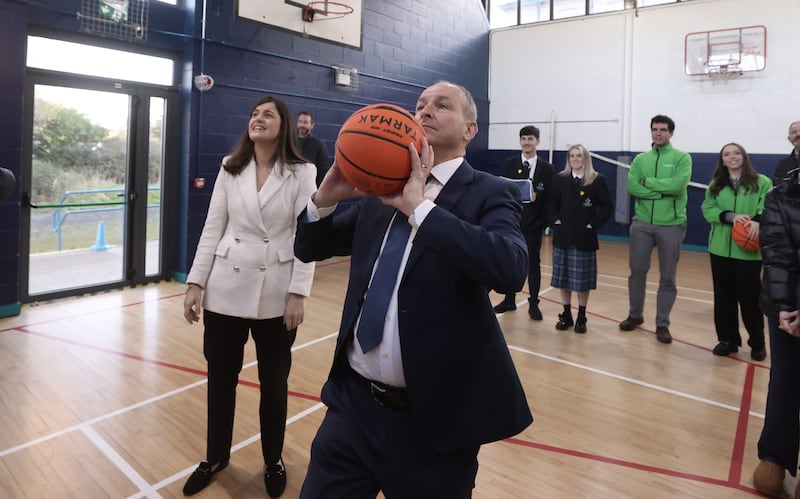 Tanaiste Micheál Martin has a shot at the hoops at St Seton's Secondary School in Ballyfermot, Dublin on a constituency visit this morning. Watching on is Dublin South Central candidate Catherine Ardagh. Liam McBurney/PA Wire