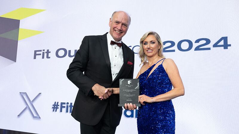 Richie Smith, business development director of BWDI Ltd, presents the fit out project manager of the year award to Michelle Perry, Oak Project Management