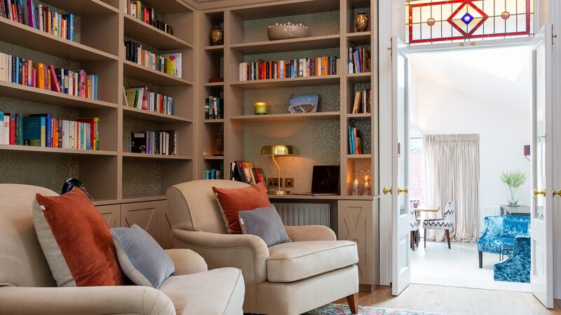 The library between the front living room and kitchen has shelving and stained-glass designed by Ruth Noble. Photograph: Matteo Tuniz