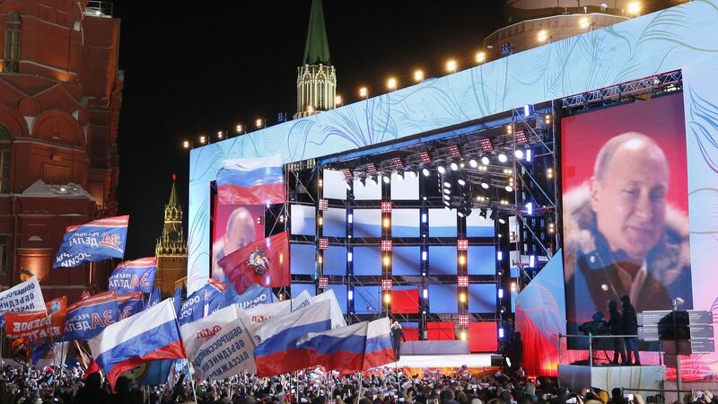 A screen shows Russian president Vladimir Putin during a rally in his support near the Kremlin in Moscow, Russia. Photograph: Maxim Shipenkov/EPA