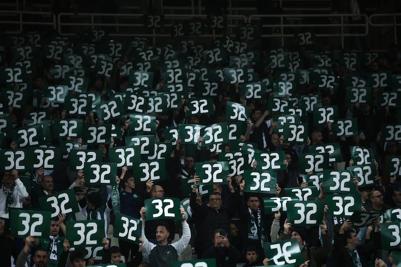 Panathinaikos fans hold up '32', the number worn by George Baldock during his time with the club. Photograph: Dimitris Kapantais/SOOC/AFP via Getty Images