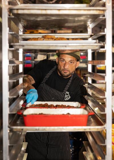 Grant Bird prepares food for a Sam Hunt concert at Jones Beach on Long Island, in the US. Photograph: Pat O'Malley/the New York Times
                      