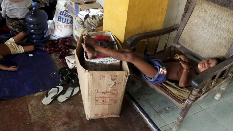 A child migrant, believed to be Rohingya, sleeps on a chair inside a shelter after being rescued from boats at Lhoksukon, in Indonesia’s Aceh Province. Photograph: Roni Bintang/Reuters