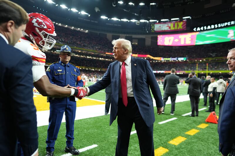 President Donald Trump shakes hands with Kansas City Chiefs defensive tackle Chris Jones before the kickoff of the Super Bowl. Photograph: Doug Mills/The New York Times
                      