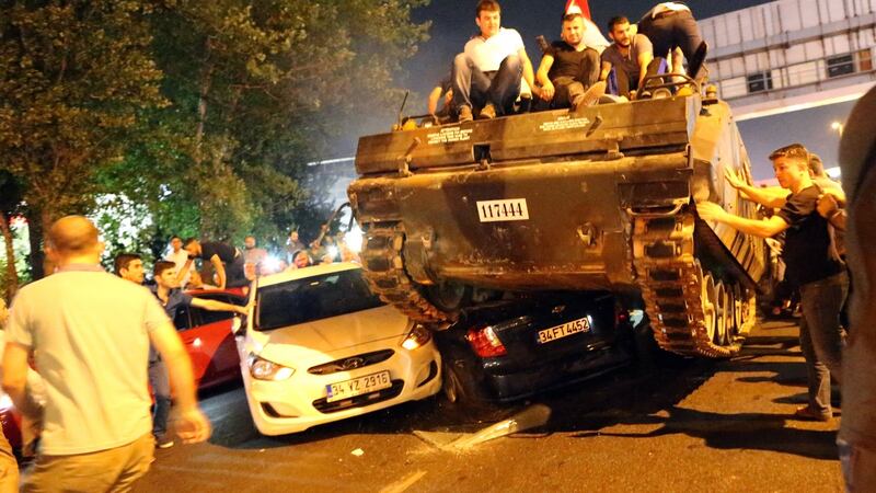 People on a tank run in Istanbul, on  July 16th, 2016 –  the night of a  failed coup attempt in Turkey. Photograph:  Tolga Bozoglu/EPA