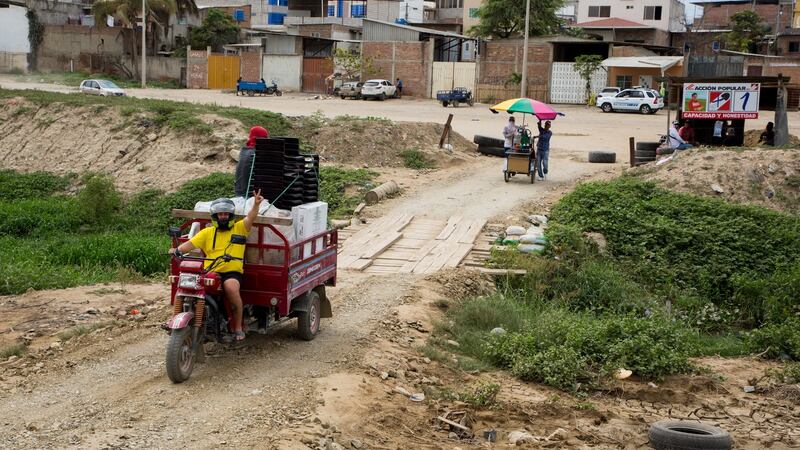 Ecuadorian police watch from a patrol car as people travel from Huaqillas, in Ecuador, to Tumbes, in Peru, over an informal border crossing. Photograph: Paul Musiol