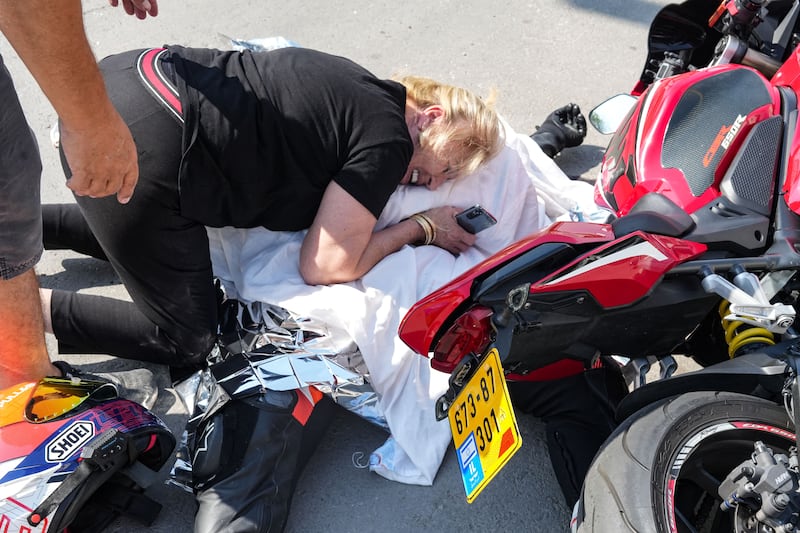 An Israeli woman weeps over the covered corpse of her nephew who was shot dead in the southern city of Sderot. Photogaph: Baz Ratner/AFP via Getty Images