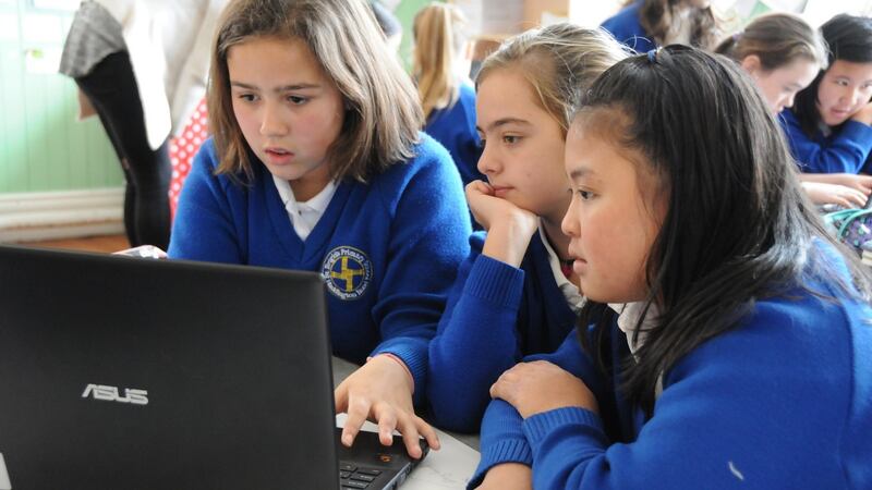 Primary schoolchildren  from Gaelscoil na bhFál in Belfast research material for  Across and Open Field, Ireland’s first history publication written and illustrated by children.