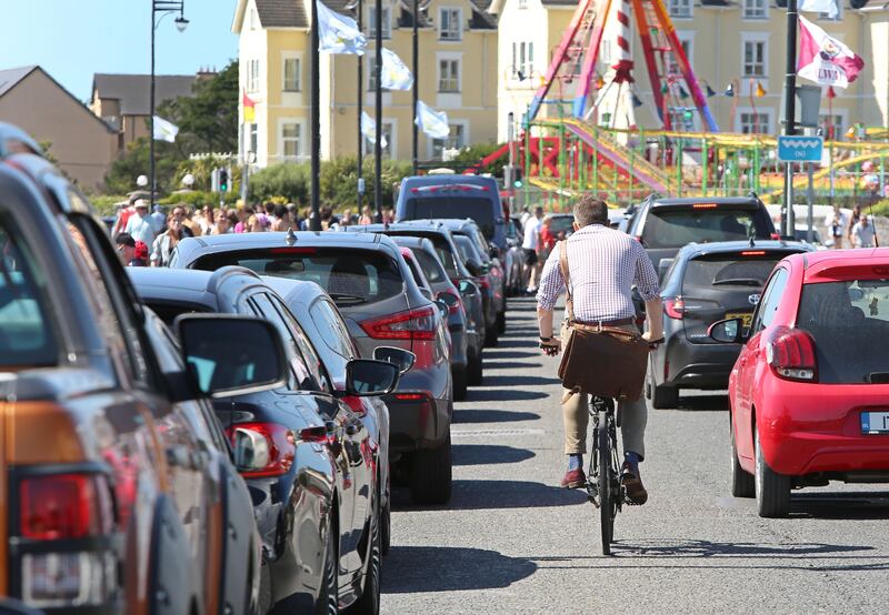  A cyclist in Salthill between traffic and parked cars. Photograph: Joe O'Shaughnessy