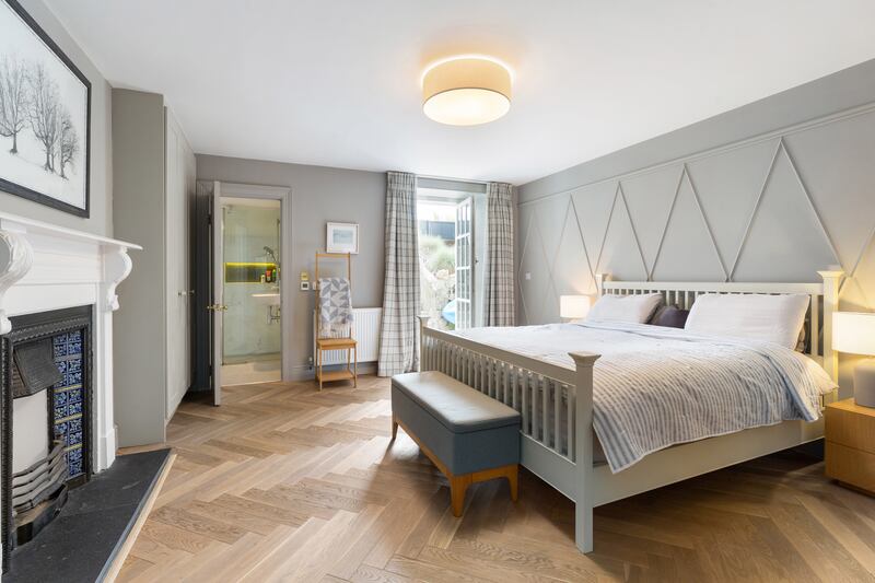 The main bedroom has a herringbone parquet floor